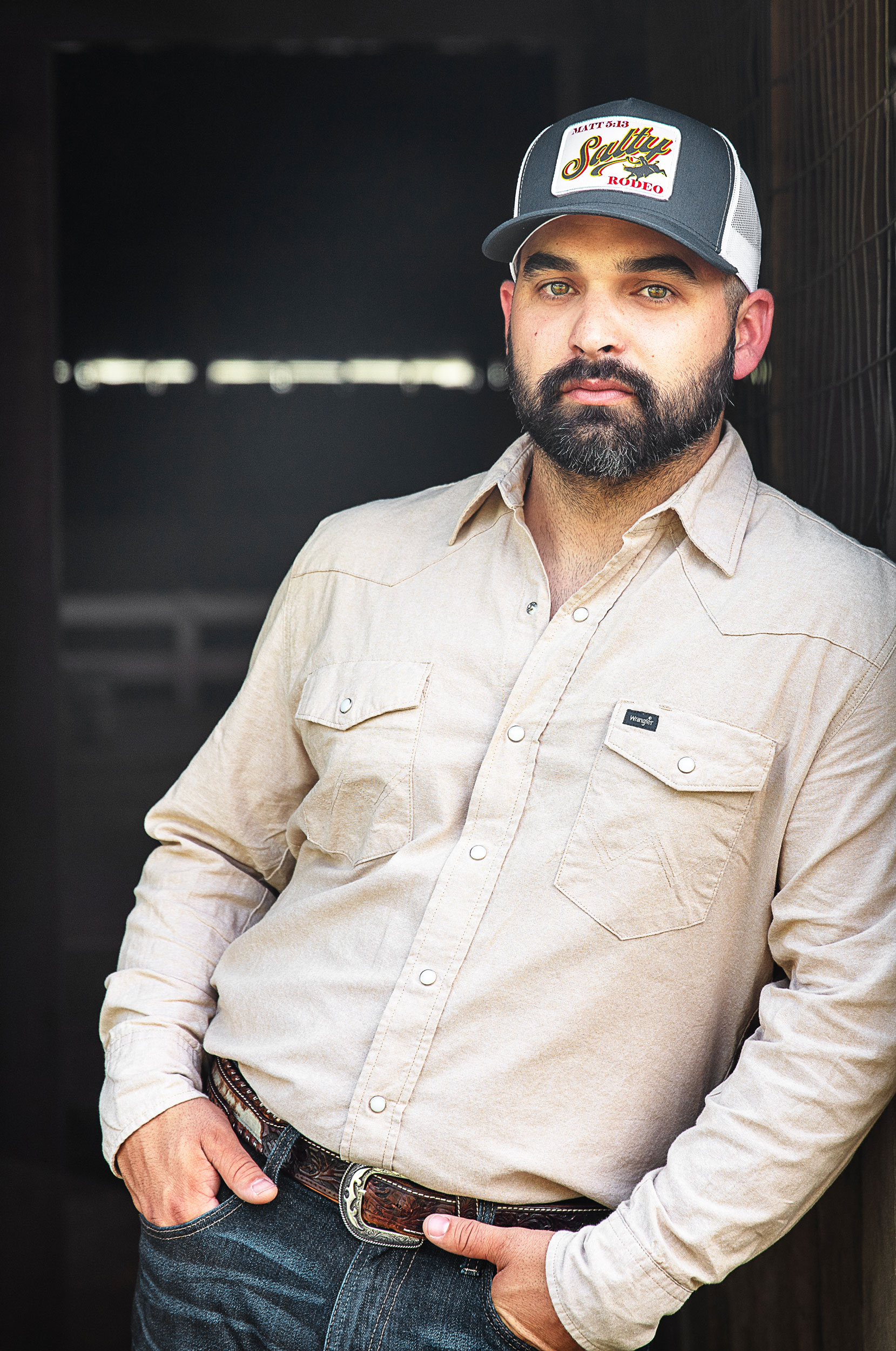 Image of Tyler Kinch leaning against wall in barn